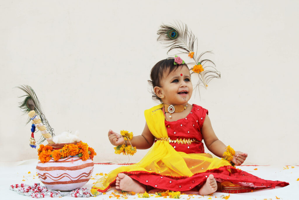 Vibrant Baby in Traditional Attire: Festive Wallpaper Delight