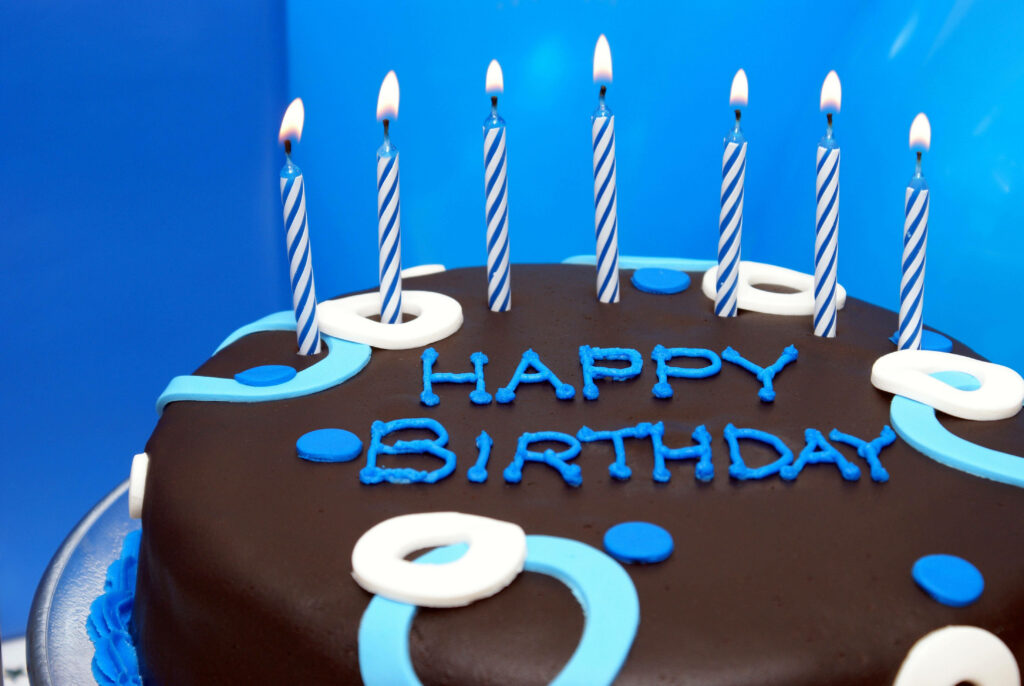Colorful Birthday Cake Wallpaper with Blue Candles & Festive Vibes