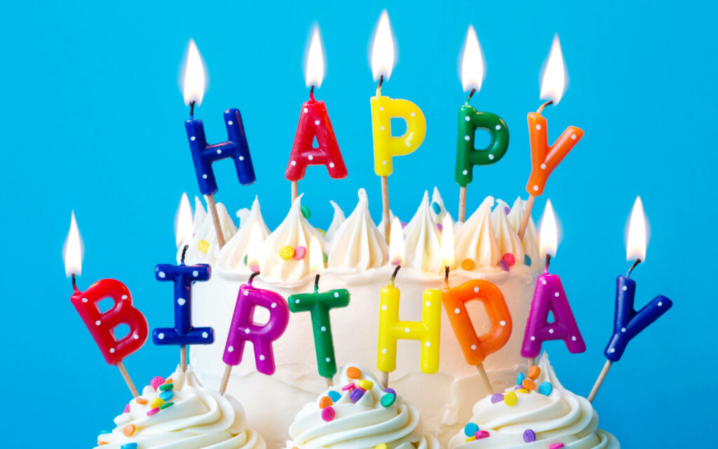 Vibrant Birthday Cake Wallpaper with Colorful Candles & Blue Background