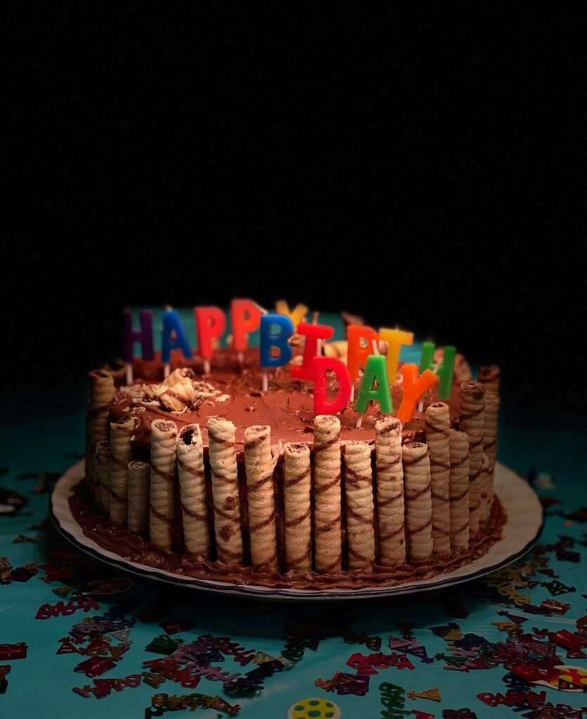 Festive Birthday Cake with Chocolate Wafers and Colorful Candles Wallpaper