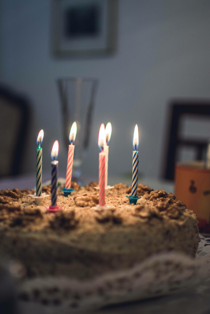 Festive Birthday Cake Wallpaper with Colorful Candles and Soft Lighting