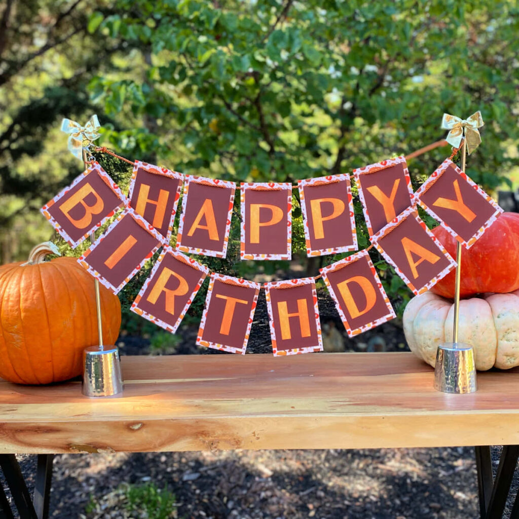 Cozy Fall Birthday Banner with Pumpkins & Green Trees Wallpaper