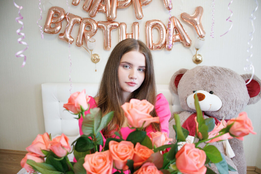 Festive Birthday Wallpaper: Young Woman with Pink Roses & Teddy Bear