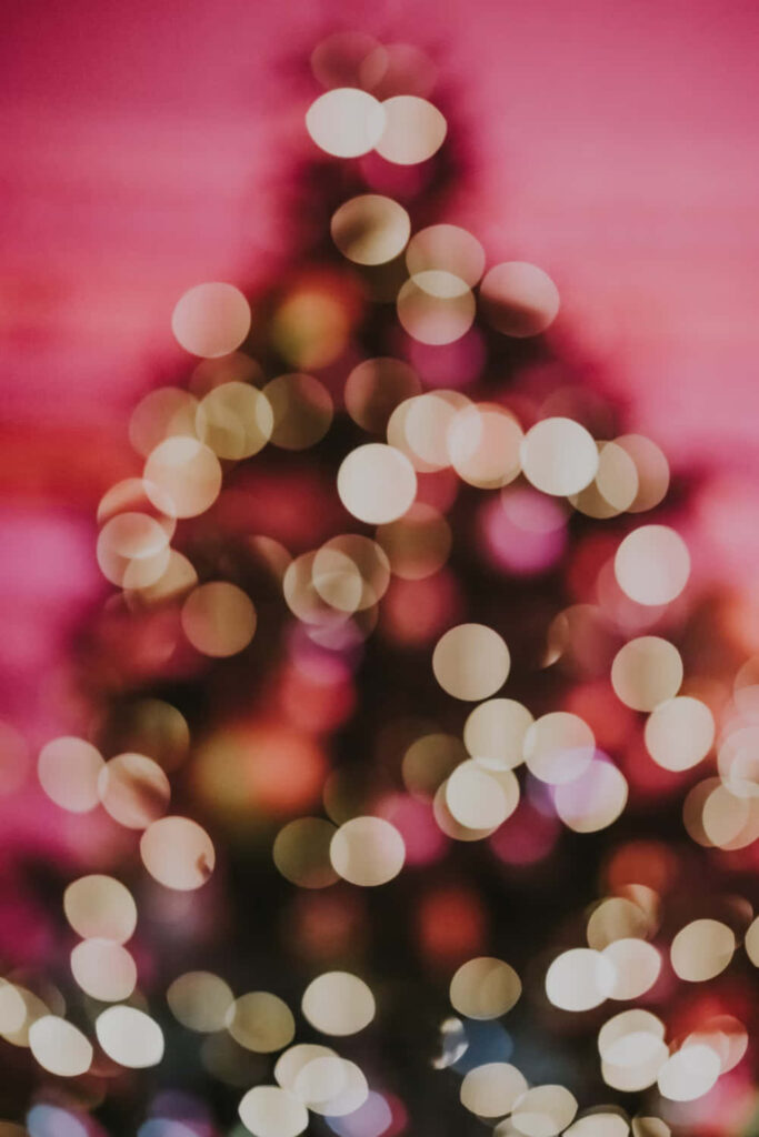 Festive Blurred Bokeh Wallpaper with Christmas Tree Lights