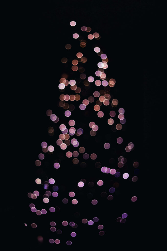 Festive Bokeh Wallpaper: Circular Light Patterns on Dark Background