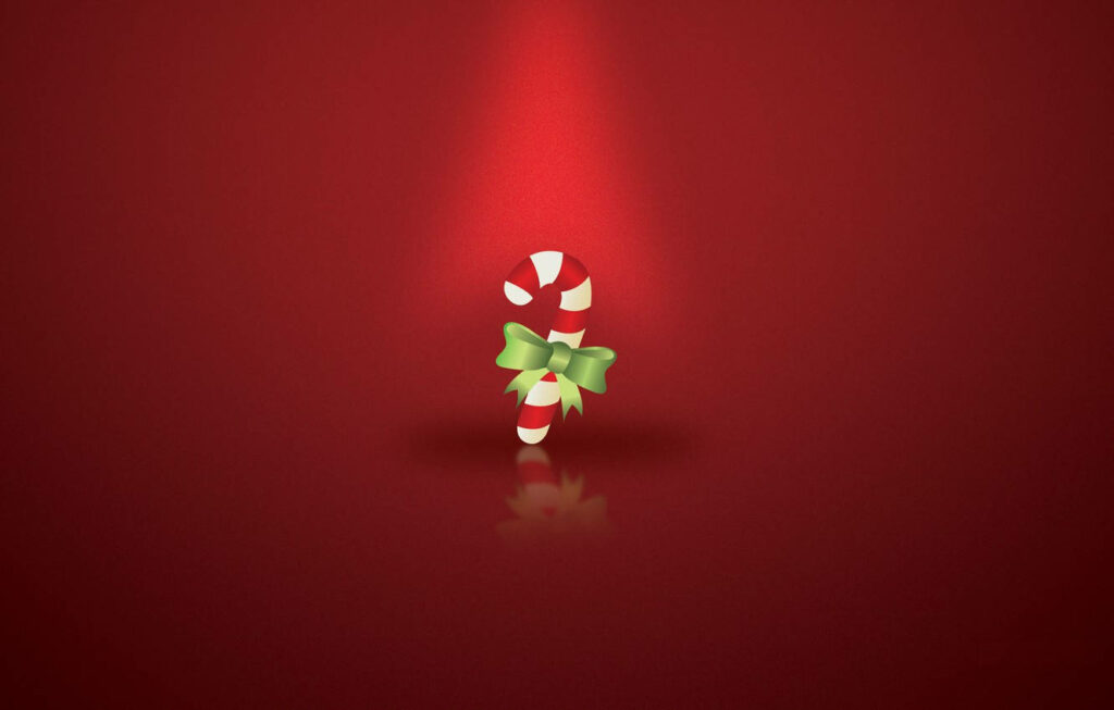 Festive Candy Cane with Green Ribbon on Red Christmas Background Wallpaper