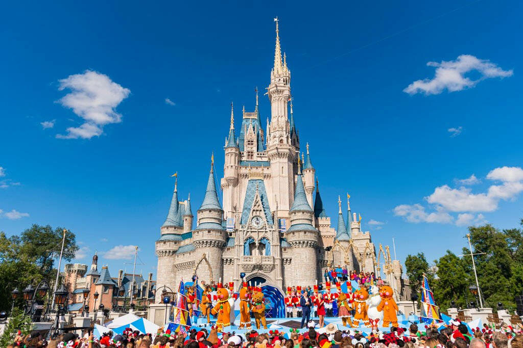 Festive Castle Wallpaper: Joyful Celebration with Costumed Characters
