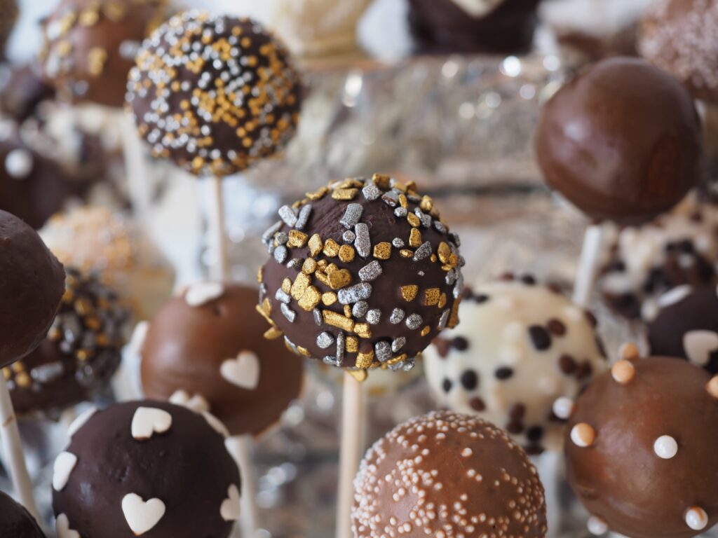 Sweet Chocolate Candy Pops Wallpaper: Festive Treat Display