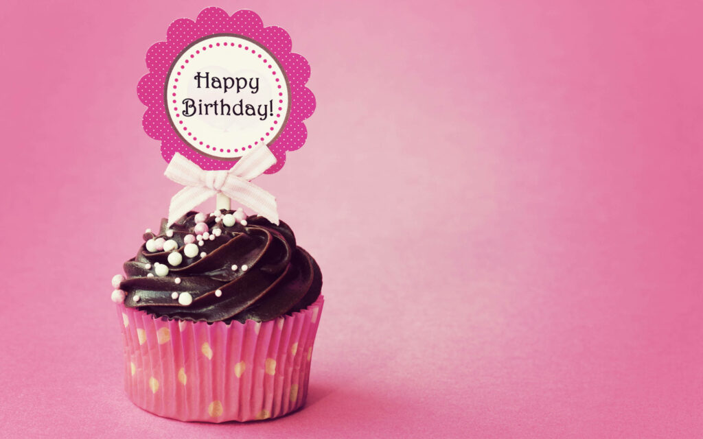 Colorful Chocolate Cupcake on Pink Background for Happy Birthday! Wallpaper