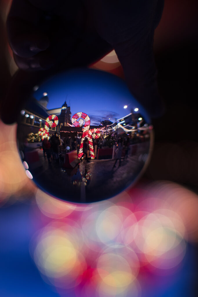 Festive Christmas Ball Reflection with Colorful Lights & Decorations Wallpaper