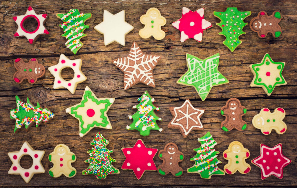 Festive Christmas Cookie Wallpaper with Colorful Icing on Wood