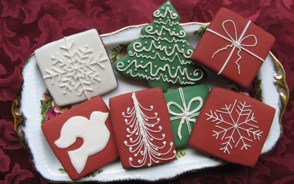 Festive Christmas Cookies Wallpaper on Elegant Red Background