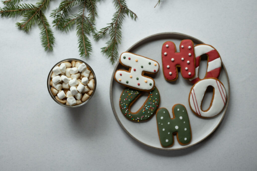 Festive Christmas Cookies with Icing and Marshmallows on Plate Wallpaper