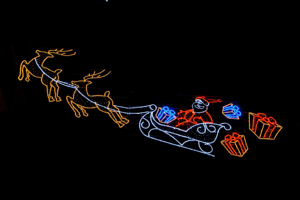 Vibrant Santa Sleigh Wallpaper: Festive Christmas Lights Background