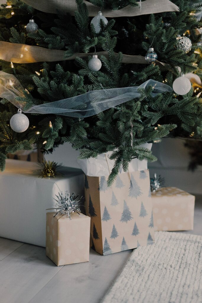 Festive Christmas Scene: Gifts Under a Decorated Tree Wallpaper
