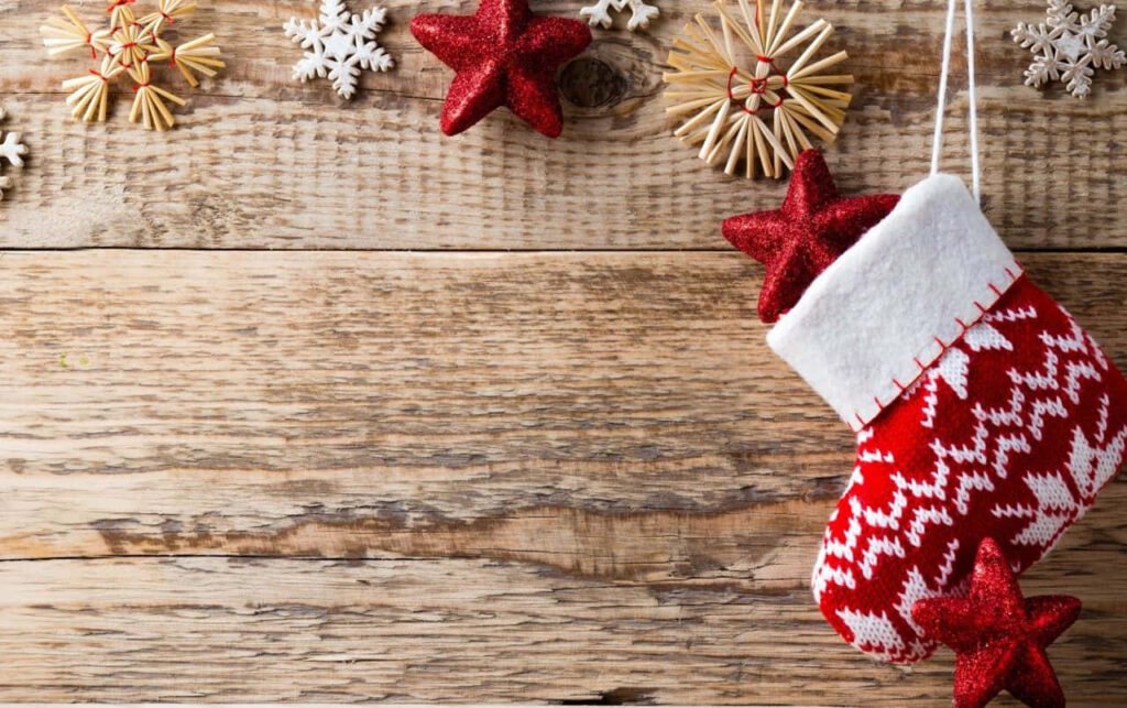 Festive Christmas Stocking Wallpaper on Rustic Wooden Background