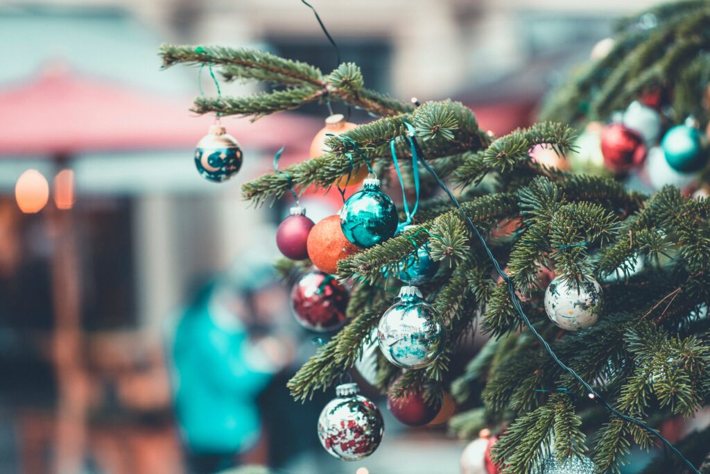 Festive Wallpaper: Colorful Christmas Tree Branch with Baubles