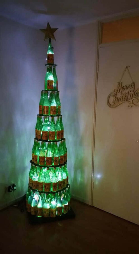 Festive Wallpaper: Christmas Tree of Illuminated Green Bottles