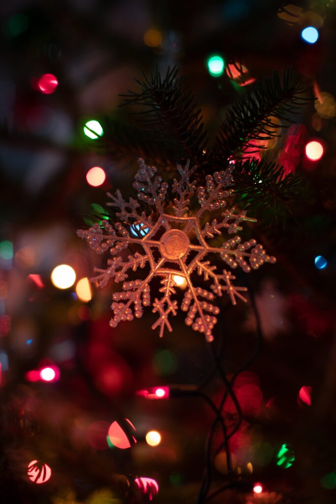 Festive Snowflake Ornament Wallpaper with Colorful Holiday Lights