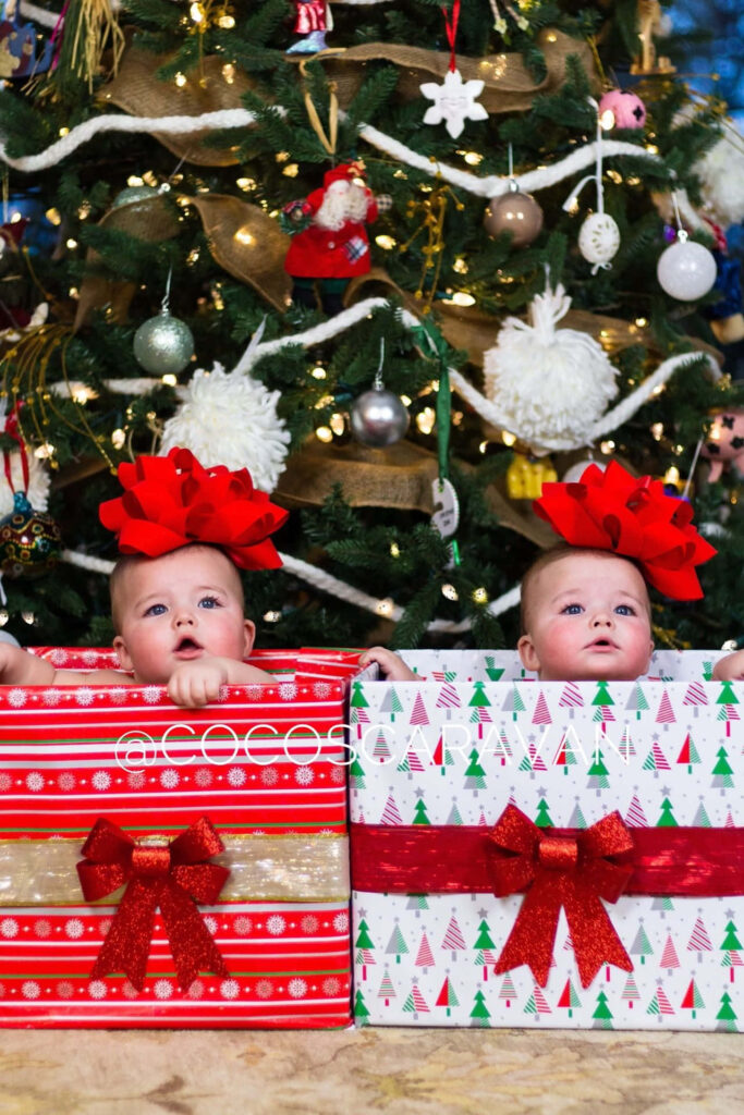 Adorable Babies in Gift Boxes: Festive Christmas Wallpaper