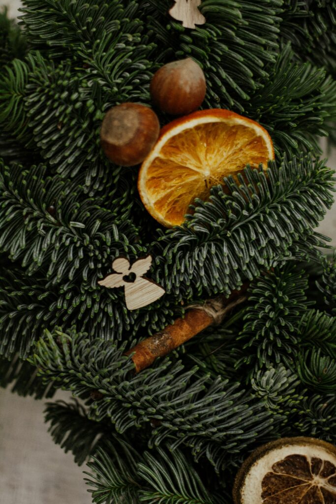 Rustic Christmas Wallpaper: Evergreen Tree with Dried Oranges & Nuts