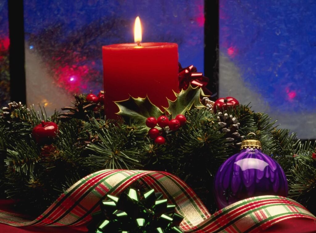 Cozy Holiday Background: Red Candle, Greenery & Festive Decor Wallpaper
