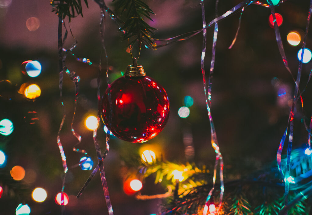 Festive Christmas Tree Wallpaper with Red Bauble & Sparkling Lights