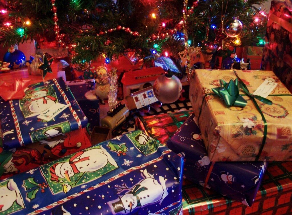 Joyful Christmas Tree Wallpaper with Wrapped Gifts - Holiday Background