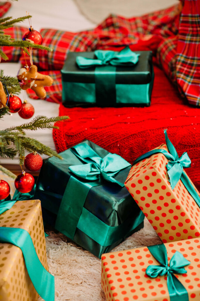 Festive Christmas Scene: Teal-Wrapped Presents & Cozy Red Plaid Wallpaper