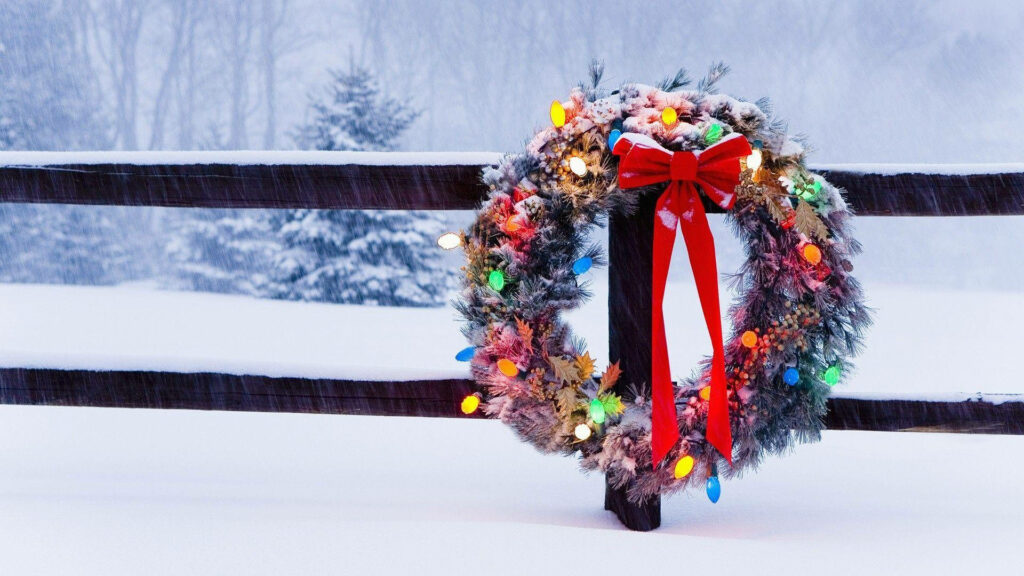 Colorful Christmas Wreath on Snowy Fence: Festive Holiday Decor Wallpaper