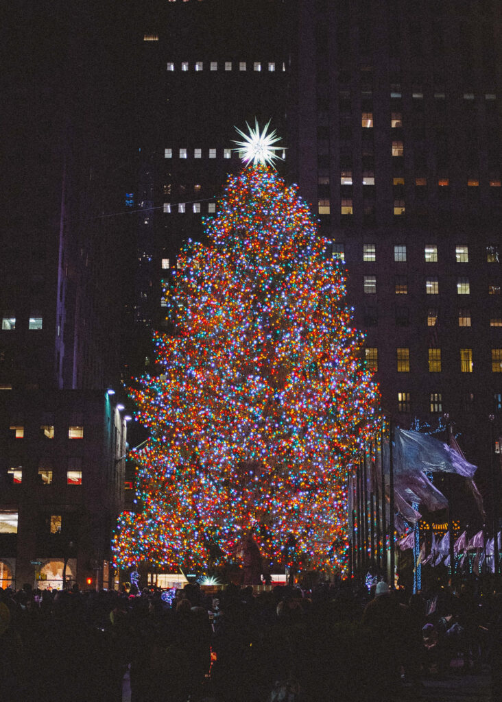 Festive Christmas Tree Wallpaper with City Nightscape Background