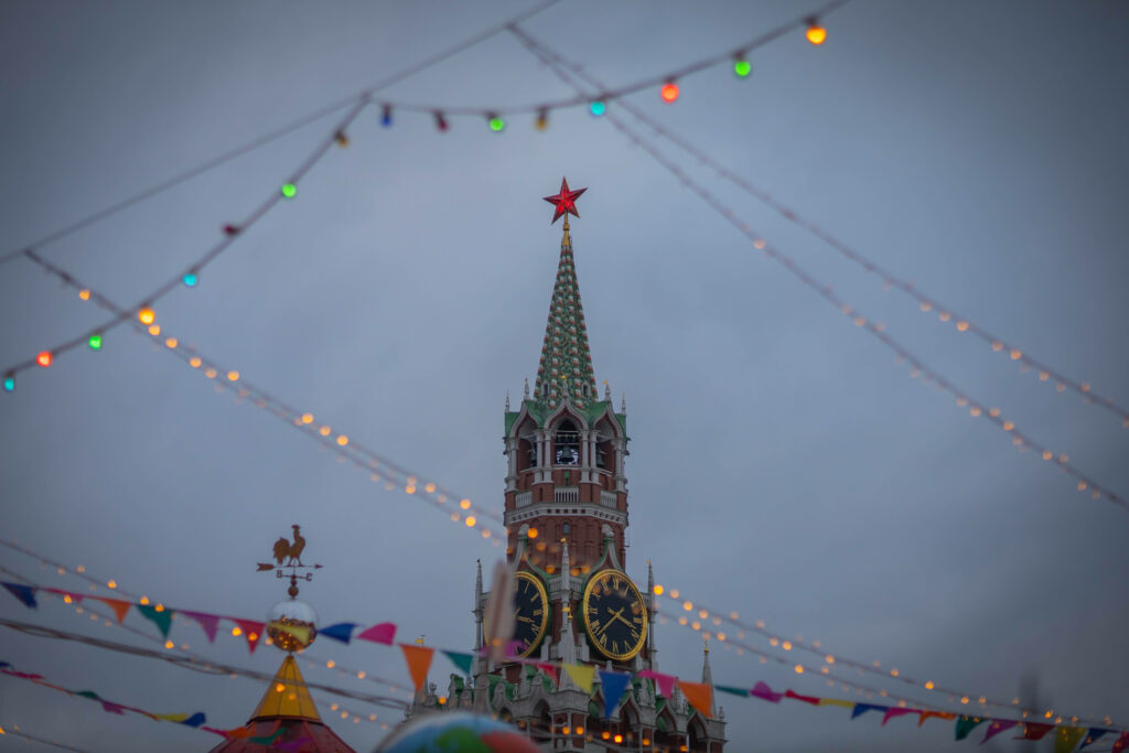Festive Clock Tower Wallpaper with Colorful Lights & Decorations