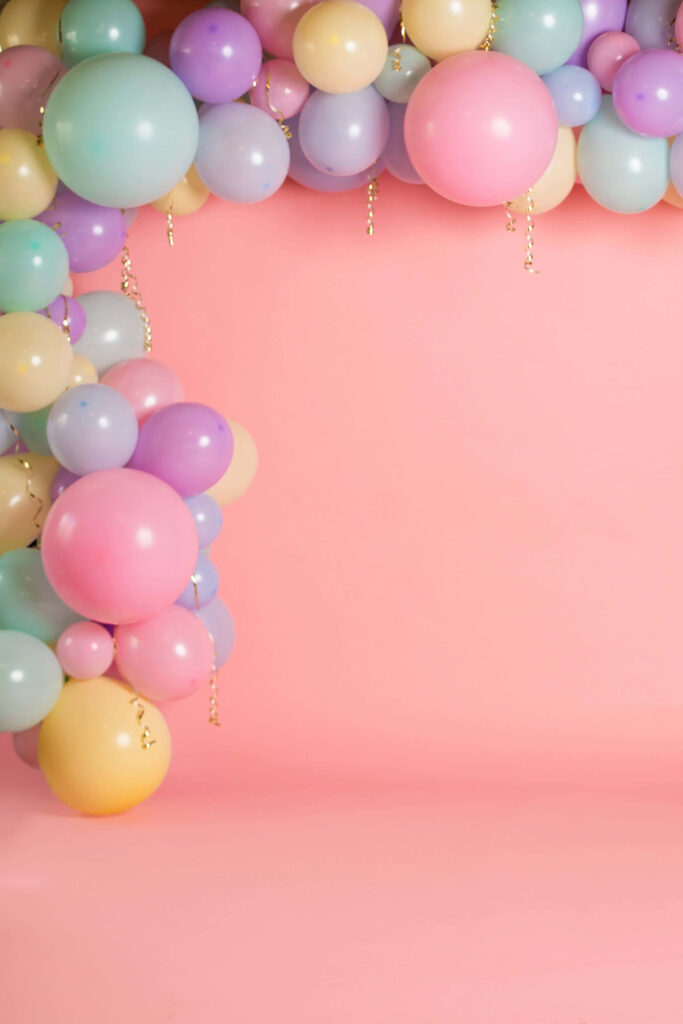 Colorful festive balloon border on smooth pink background for cheerful celebration decor wallpaper