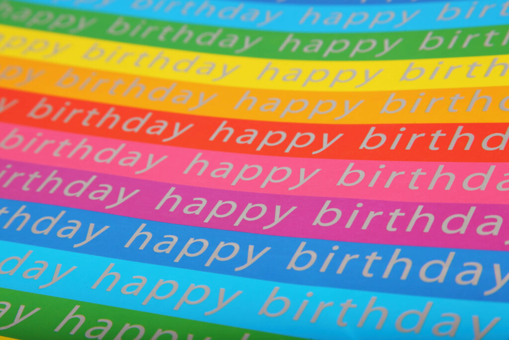 Vibrant Birthday Wallpaper: Colorful Stripes & Playful Font Design
