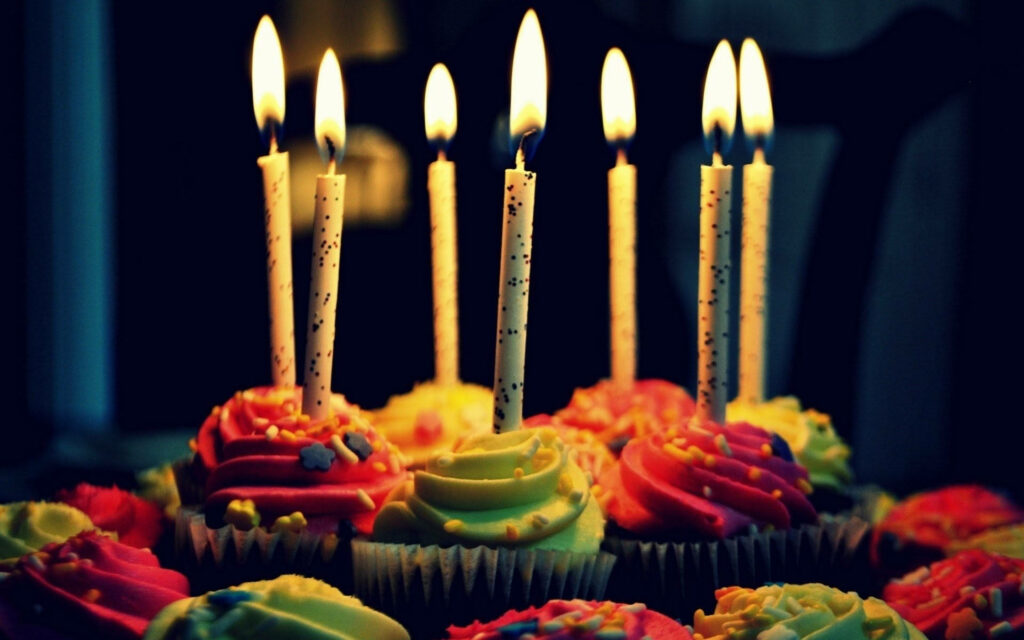 Festive Cupcake Wallpaper: Colorful Frosting & Candles Background