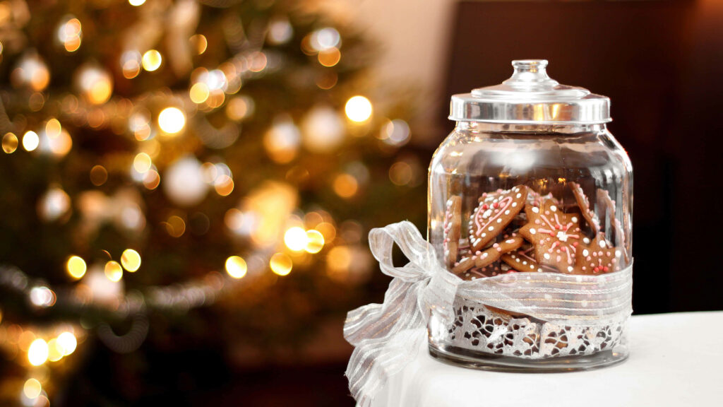 A Festive Delight: A Captivating 8k Christmas Background Photo Showcasing a Ribbon-adorned Cookie Jar on a Table, Crafted with Selective Focus Wallpaper