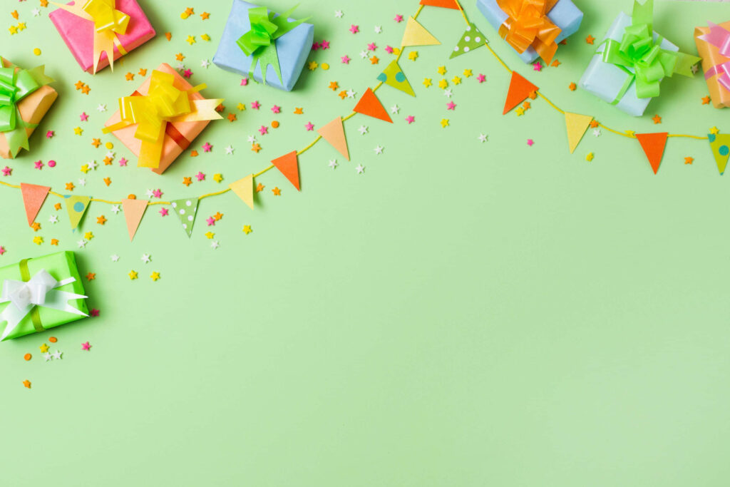 Vibrant Green Background with Festive Colorful Gift Boxes & Stars Wallpaper