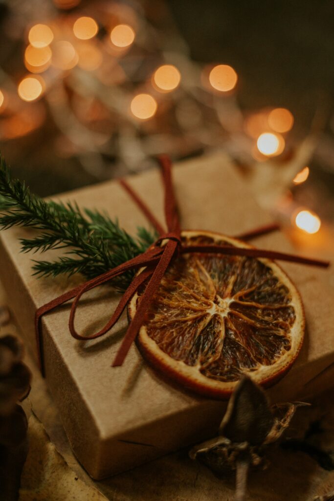 Cozy Gift Box Wallpaper: Dried Orange & Greenery with Festive Lights