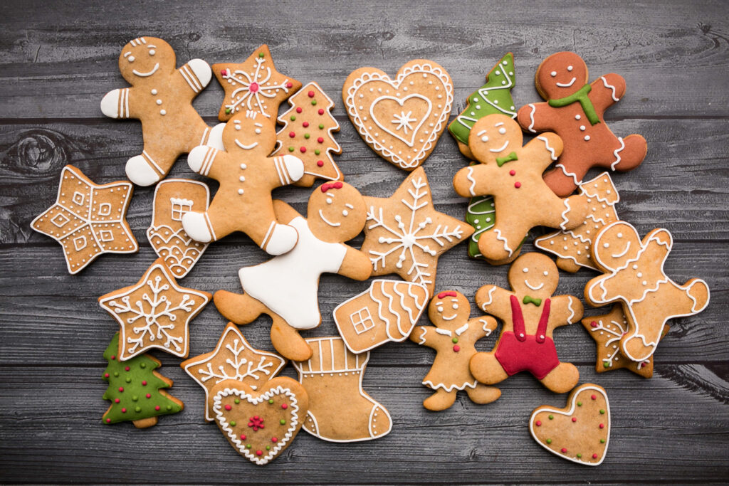 “Charming Holiday Gingerbread Cookies on Rustic Wooden Background” Wallpaper