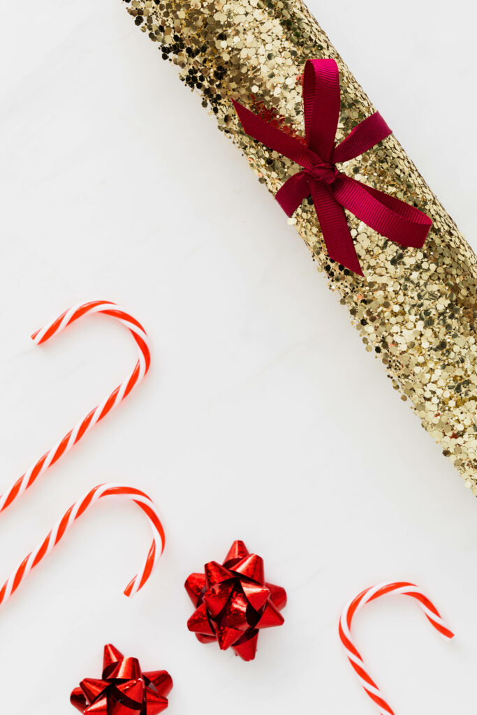 Festive Gold Glitter Wallpaper with Red Ribbons & Candy Canes