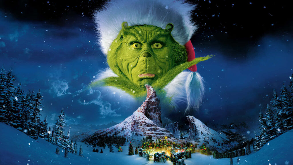 Whimsical Grinch Santa Hat Wallpaper with Cozy Christmas Village