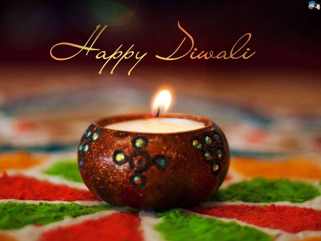 Festive Happy Diwali wallpaper with glowing diya candle in ornate bowl on vibrant Rangoli background