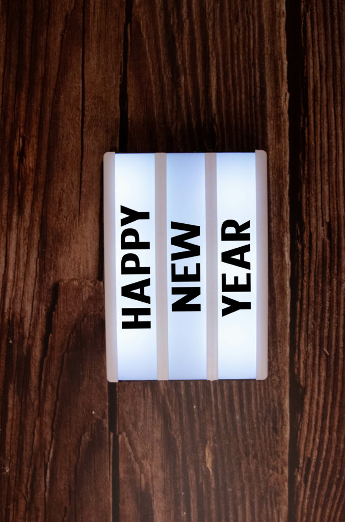 Festive New Year Lightbox Wallpaper on Rustic Wood Background