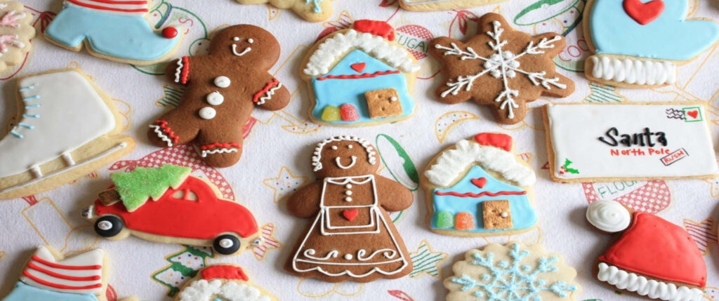 Festive holiday cookies wallpaper with gingerbread people snowflakes houses and Santa mail envelope
