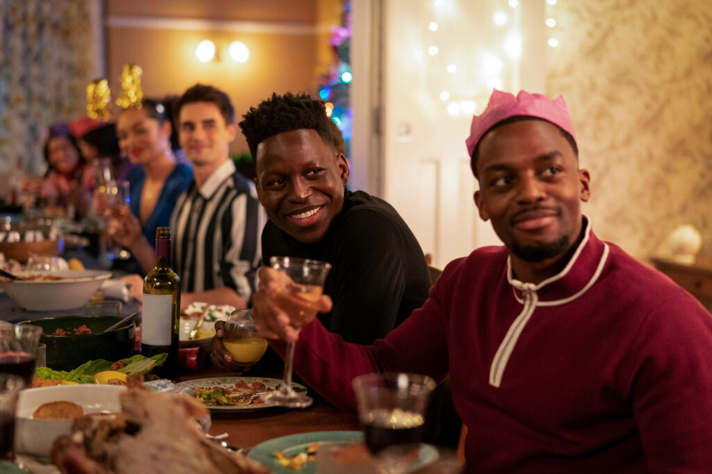 Festive Ted Lasso Holiday Dinner Wallpaper: Sam Obisanya & Friends