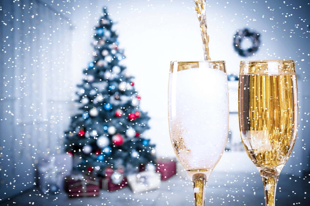 Festive Wallpaper: Champagne Toast & Christmas Tree in Snowfall