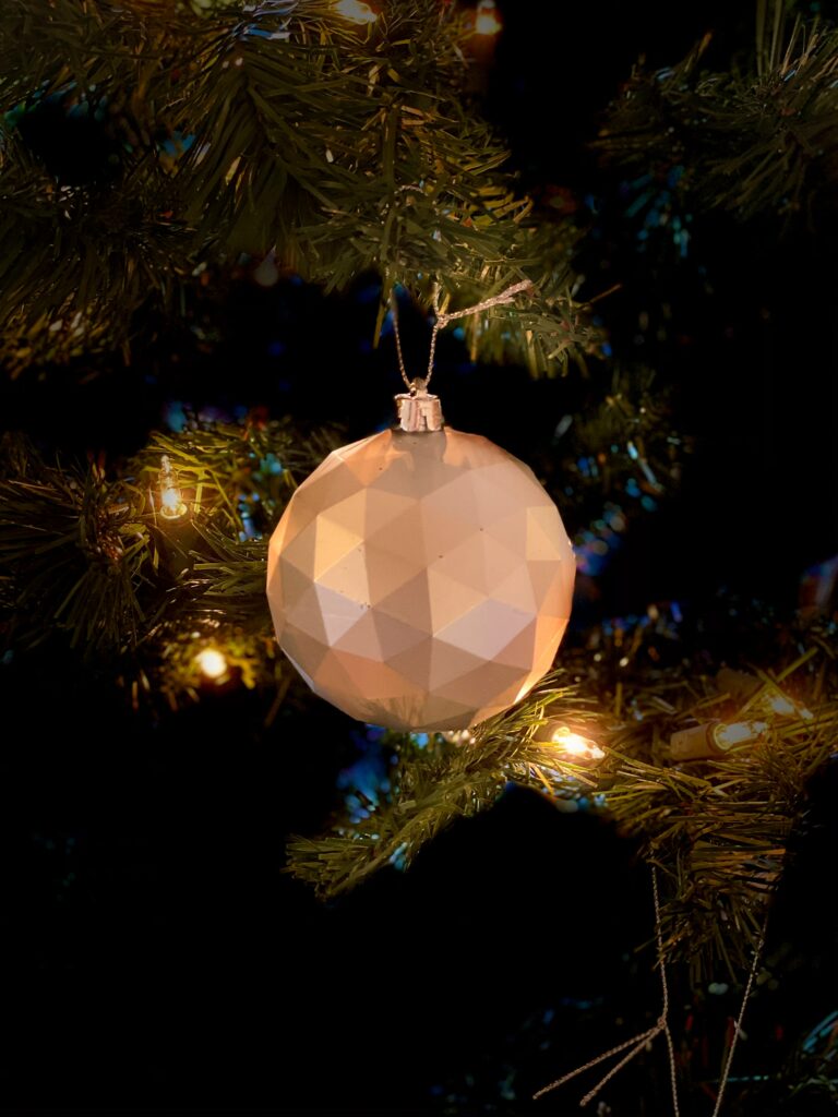 Festive Geometric Ornament on Christmas Tree - Cozy Holiday Background Wallpaper
