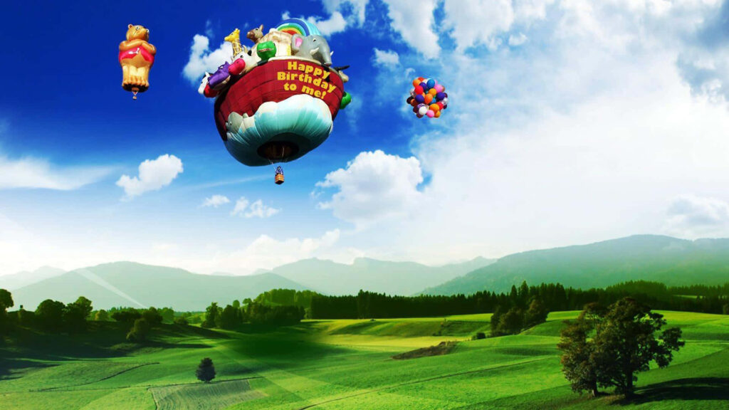Festive Hot Air Balloon Birthday Wallpaper Over Green Landscape