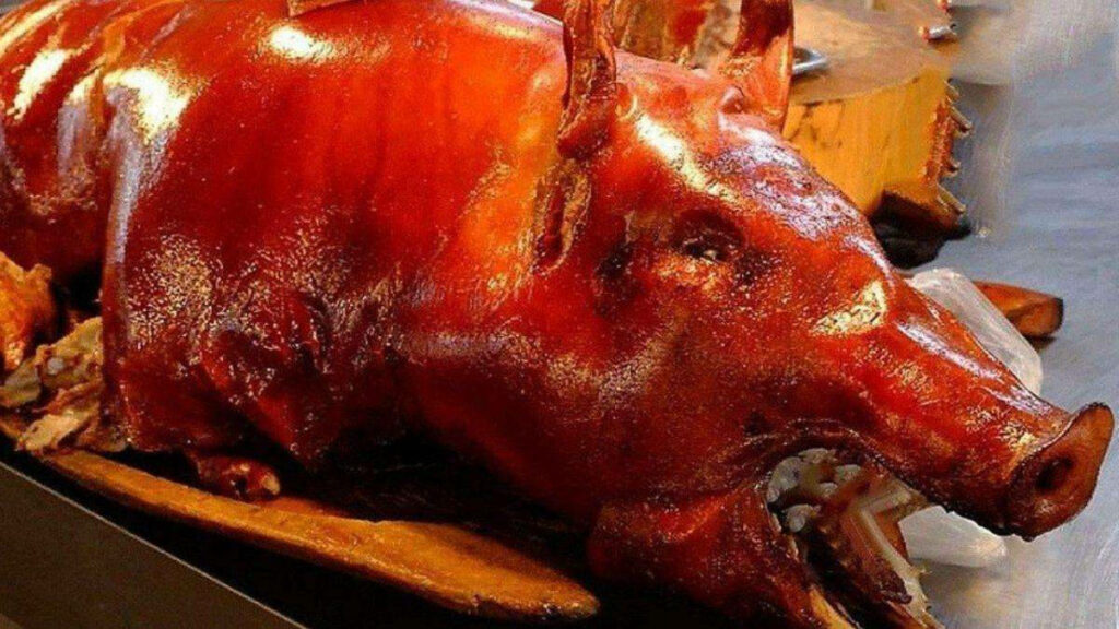 Golden Roasted Lechon Wallpaper - Festive Culinary Delight Background