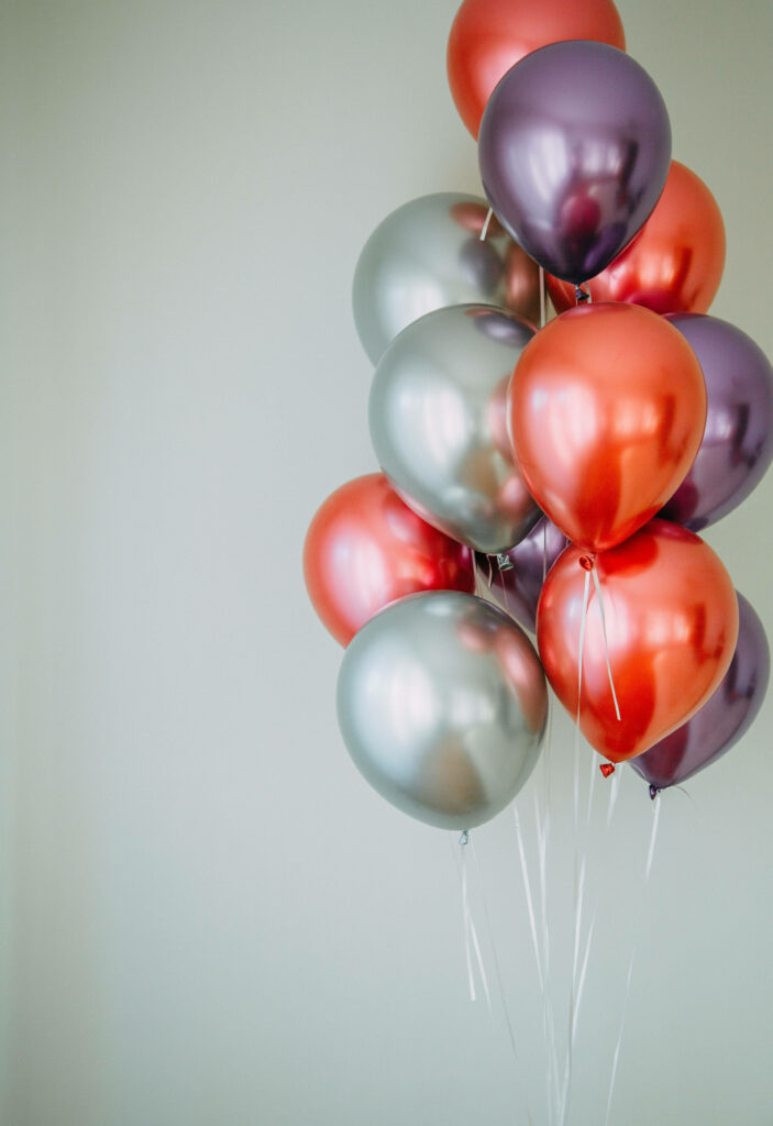 Festive Wallpaper: Shiny Floating Balloons in Red, Purple & Silver